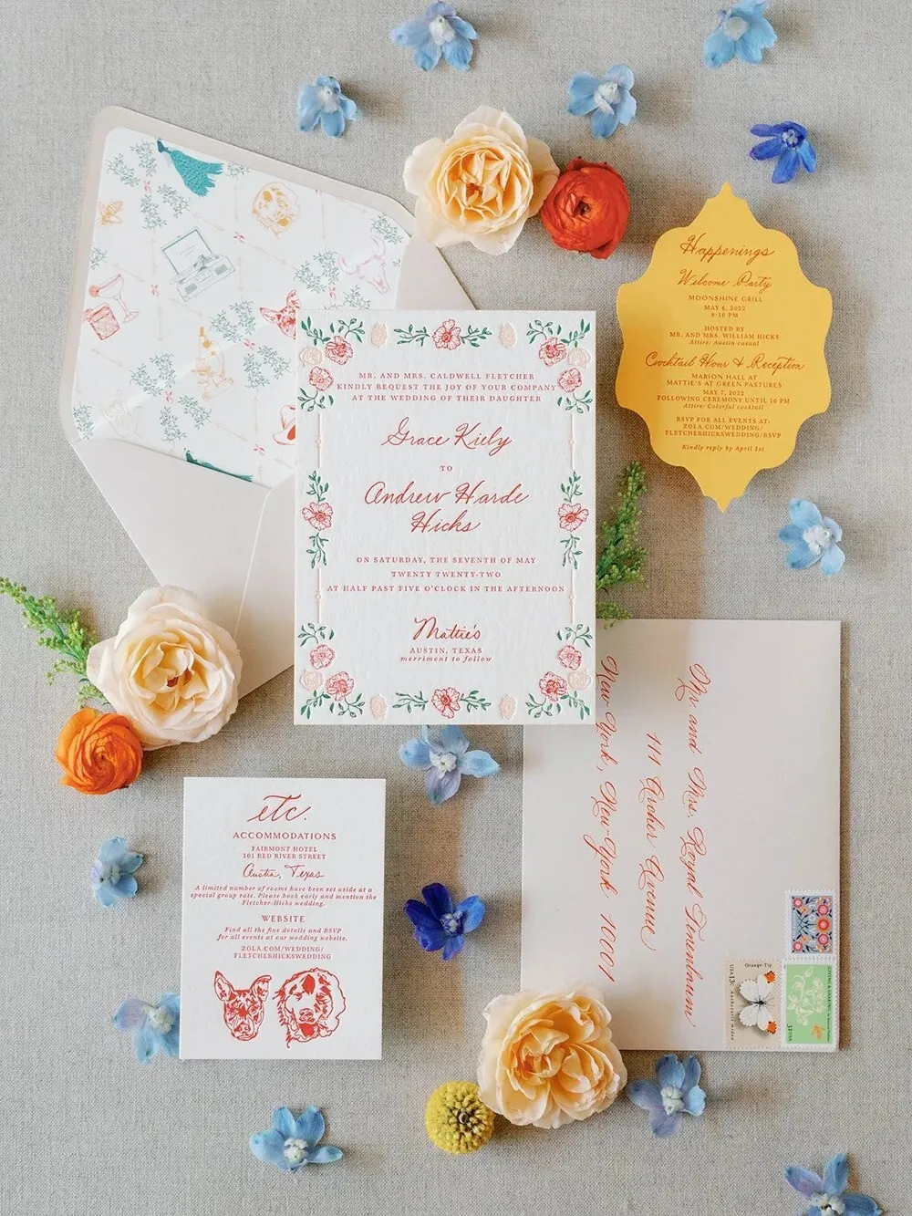 Colorful invitation suite with hand-painted floral borders, a scalloped yellow details card, and loose blooms